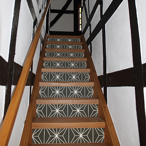 Contremarches d'un escalier traditionnel décorées par des autocollants décoratifs représentant des formes géométriques noirs